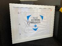 AT & T Byron Nelson flag signed by Jordan Spieth, in white frame 202//152