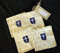 Set of 4 cocktail napkins in white/gold embroidered w/Jesuit shield on each 202//176