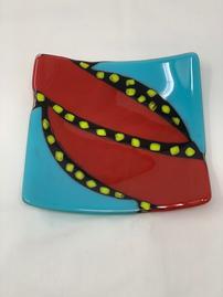 Turquoise glass plate with red,yellow & black pattern 202//269